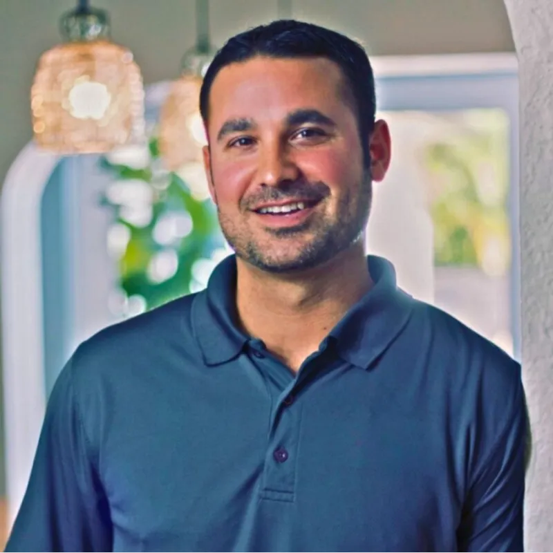 Phil Tori, smiling, in a blue polo shirt